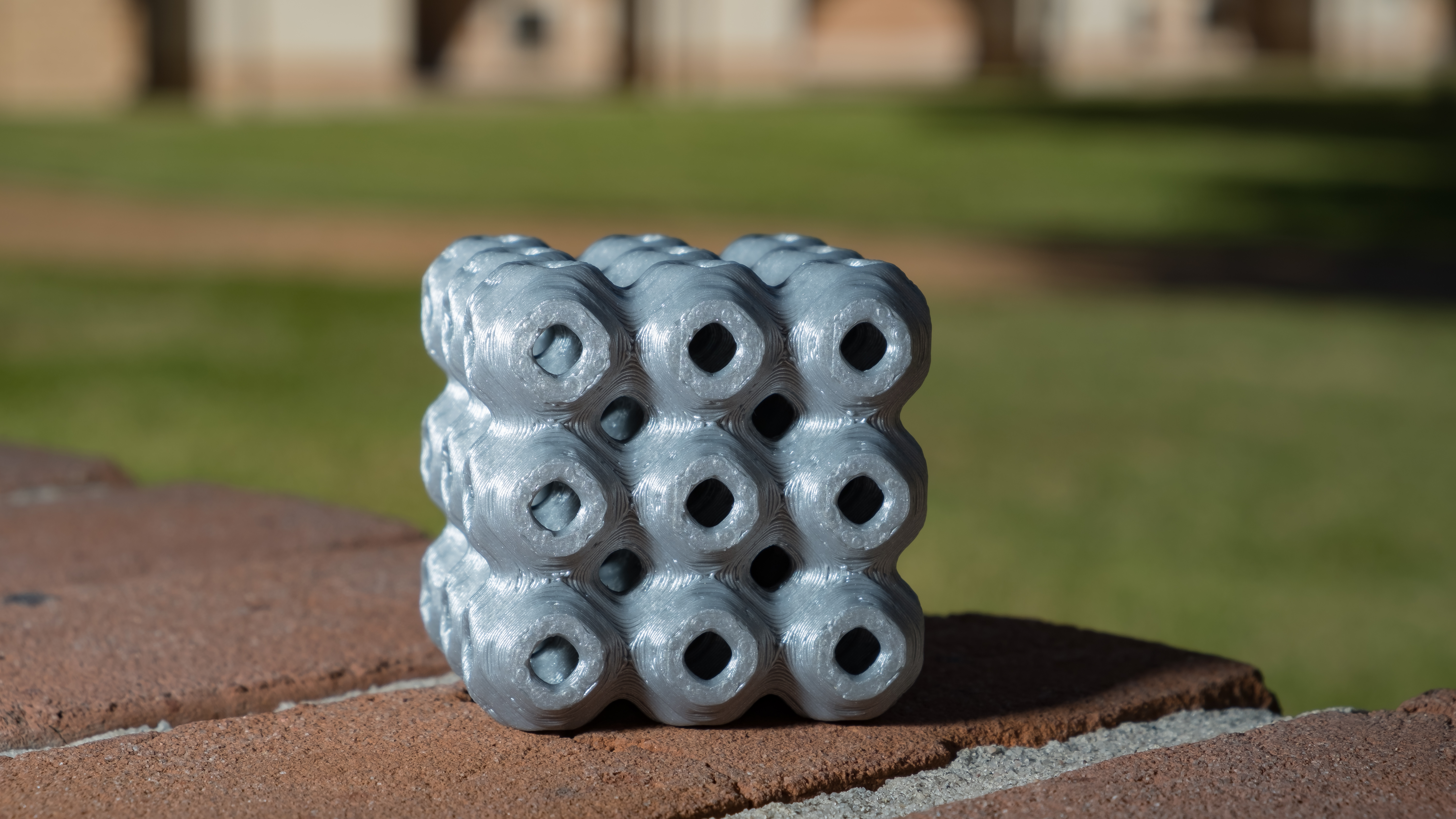 A schwarzite created on a 3D printer by materials scientists at Rice University. The curved surface repeats throughout the structure, which showed excellent strength and deformation characteristics in tests at Rice. Photo: Jeff Fitlow/Rice University.