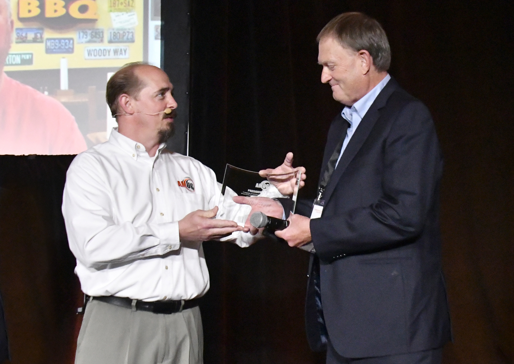 Scott Crump (right) accepts the President's Award on behalf of Terry Hoppe, presented by Carl Dekker.