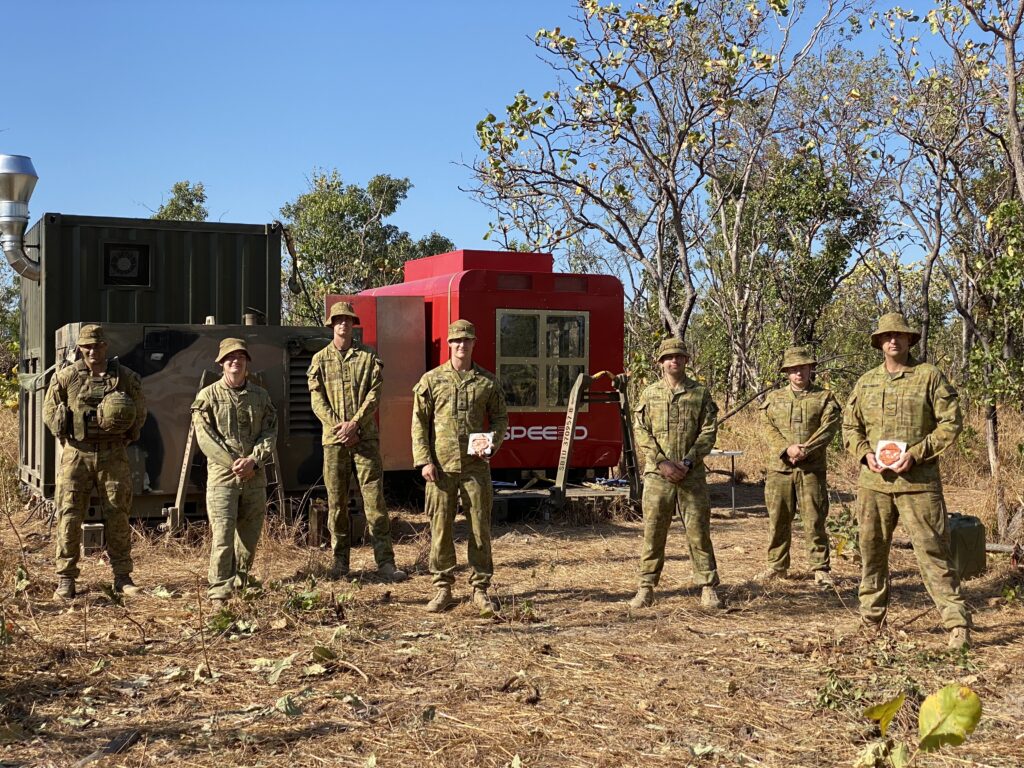 Australian Army Soldiers standing in front of a WarpSPEE3D printer in 2020.