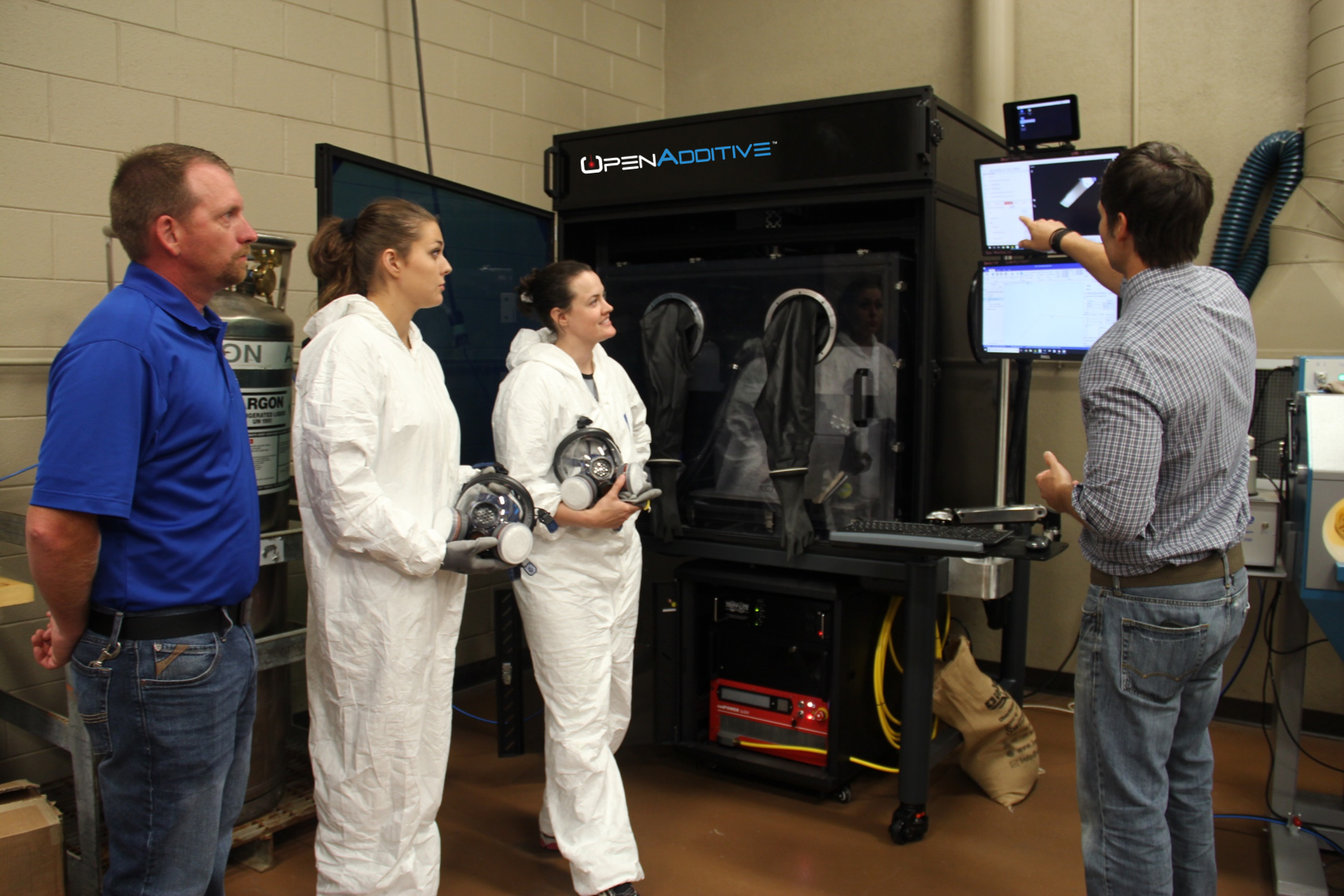Professor Eric Wooldridge with students and Curtis Cash, professor of machine tool technology.