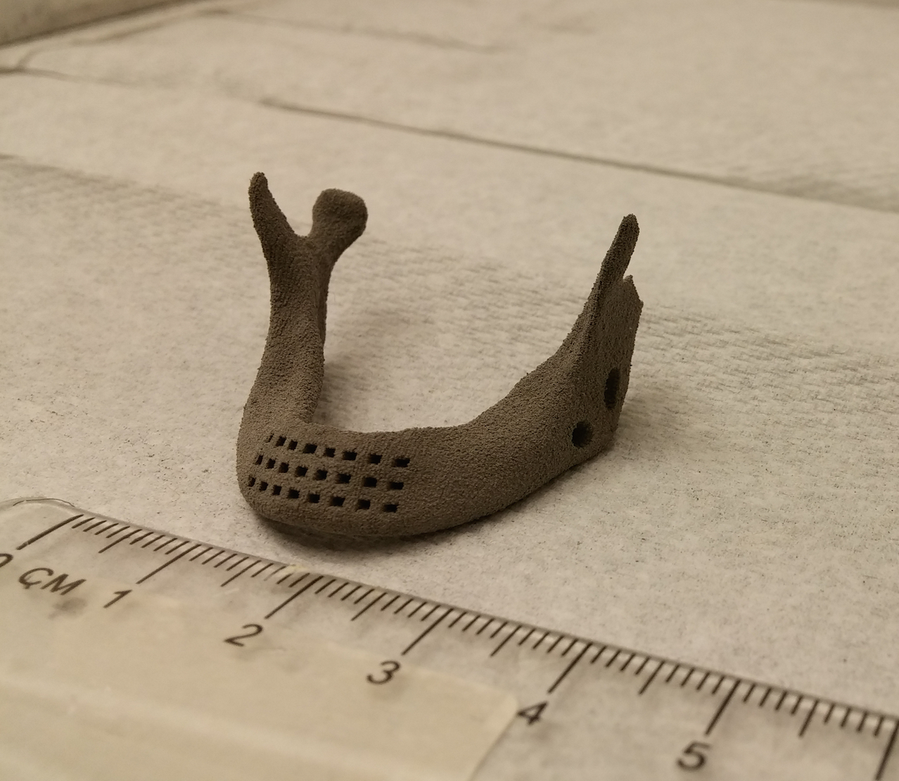 A scaled down porous human mandible made out of the alloy using the binder jetting approach.