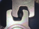 Figure 3: The powdered metal part at lower left was impregnated with IMPCO’s PoreSeal resin and Surface Matrix Sealing™ processing prior to plating.  The part at upper right was not impregnated — note the corrosion in the form of black spots. [Photo courtesy of Anoplate Corporation, Syracuse, N.Y.]