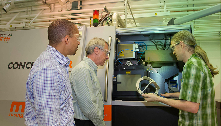 From left: Ibo Matthews, Wayne King, and Gabe Guss examine a 3D-printed part manufactured using the selective laser melting process. Photo courtesy Julie Russell/Eric Duoss LLNL.