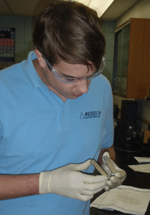 Figure 10.  Lab technician conducting the ASTM G48 test, a common procedure for detecting pitting corrosion.