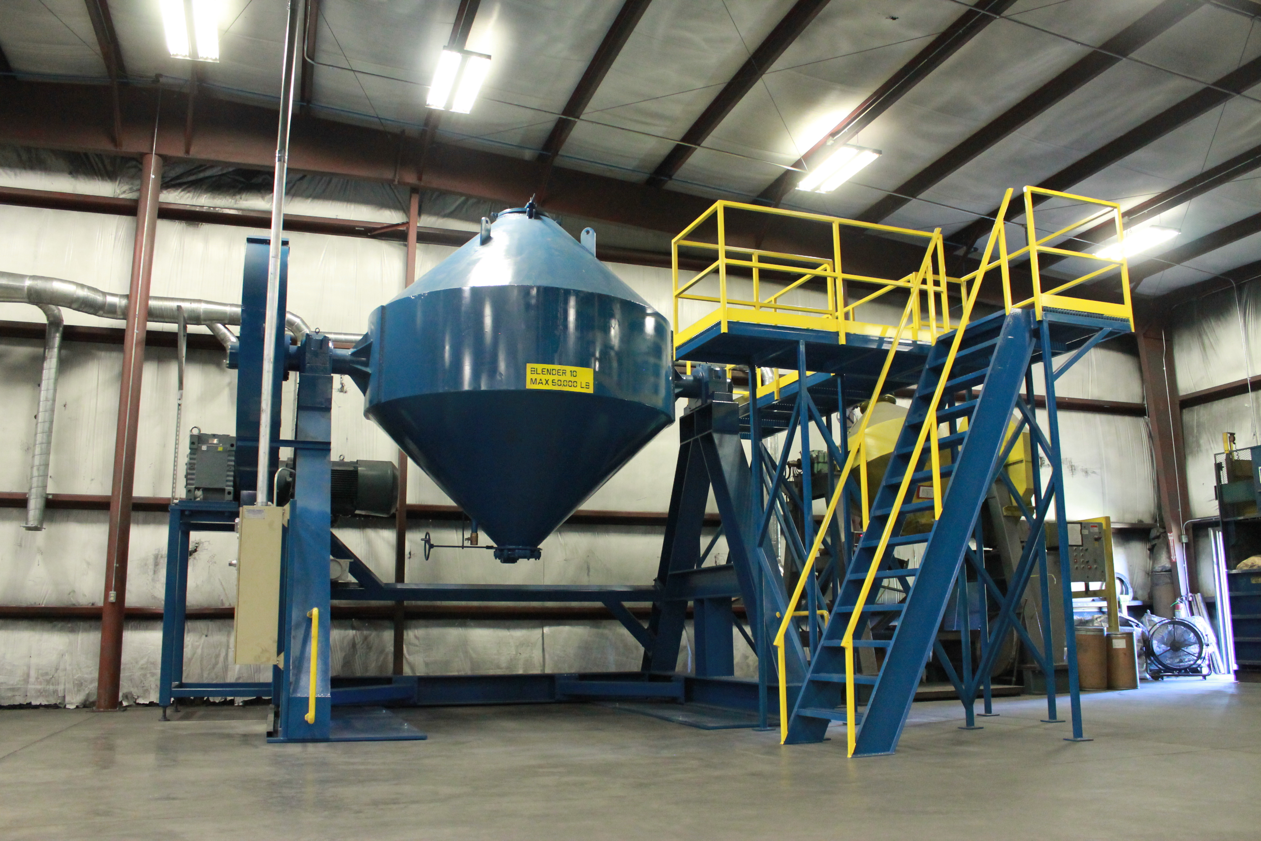 The blender consists of an opposed/double cone design with a maximum metal powder mix operating capacity of 60,000 lbs and total volume of 450 ft3.