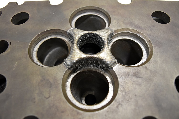 A 3D printing process developed at Oak Ridge National Laboratory repairs a Cummins engine. Photo courtesy Brittany Cramer/Oak Ridge National Laboratory.
