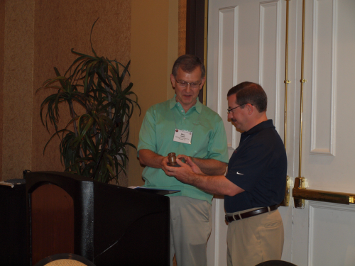 Former IHEA President, Max Hoetzl with Surface Combustion presents gavel to incoming IHEA President, Tim Lee with Maxon, A Honeywell Company.