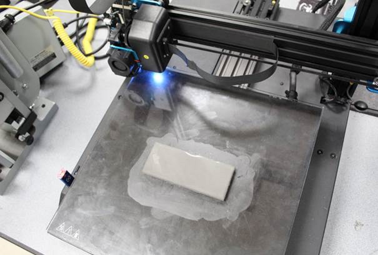 A low-cost desktop 3D printer producing infused stainless steel plate.
