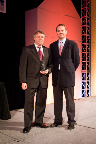 Roger Lawcock (left) receives APMI Fellow award from APMI President Dean Howard. Photo courtesy of MPIF.