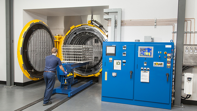 Processing titanium in an all-metal hot zone furnace within a climate controlled room.