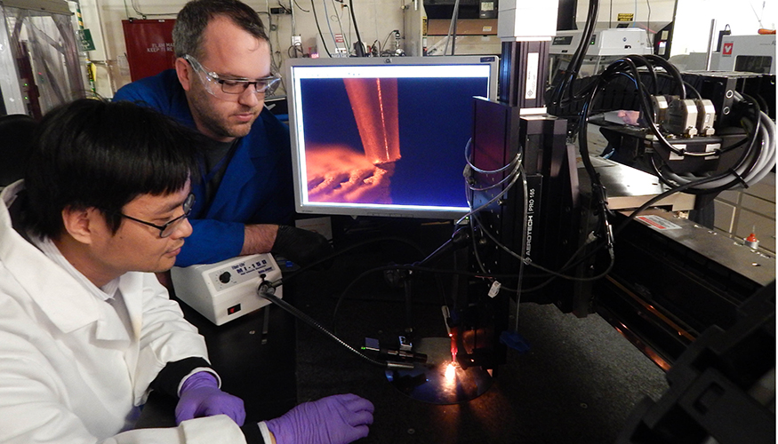 LLNL scientists Cheng Zhu (left) and Kyle Sullivan are using AM to print custom electrically conductive substrates. Photo courtesy Julie Russell/Eric Duoss LLNL.