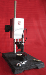 Picture of probe stand being used to measure small parts.  
Picture courtesy of UPA technology.