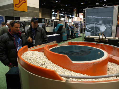 FABTECH attendees stop by the ALMCO booth to get an up-close look at the latest in vibratory finishing technology.