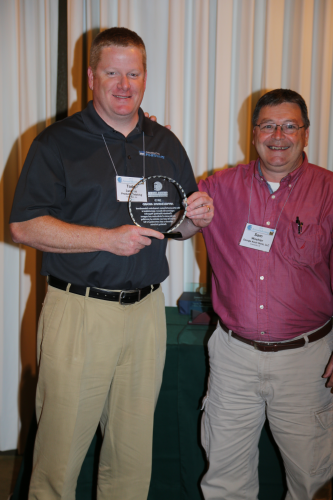 Todd Luciano, left, proudly accepts CCAI Appreciation Award from Sam Woehler, CCAI National president.