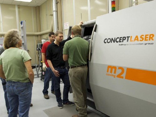 Engineers at Marshall Space Flight Center observe the new Selective Laser Melting machine.(NASA/MSFC/Andy Hardin)