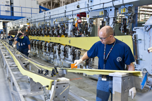 Boeing mechanic Larry Freeman prepares a part for loading into the automated spar assembly tool at the 737 factory in Renton, Wash. The spar— a supportive beam that runs the length of the wing structure—is the first piece assembled at the new production rate of 35 airplanes a month for the Next-Generation 737.