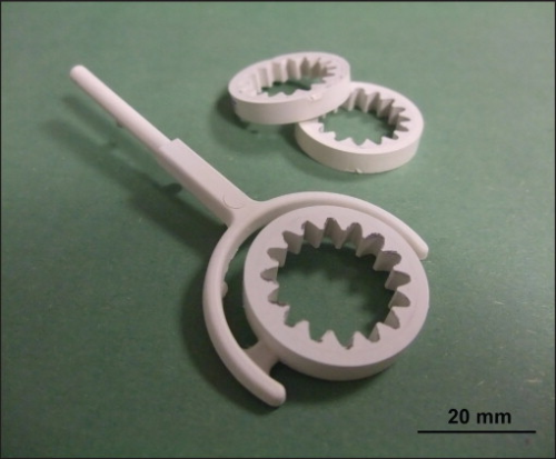 Figure 6. Two-component ceramic gear wheels with runner system for the outer ring in the green state.
